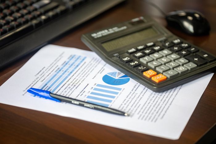 Calculator and financial reports on a desk