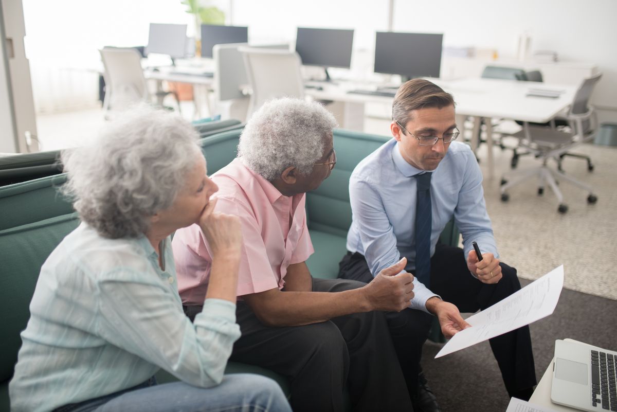 Advisor reviewing a financial plan with clients in an office