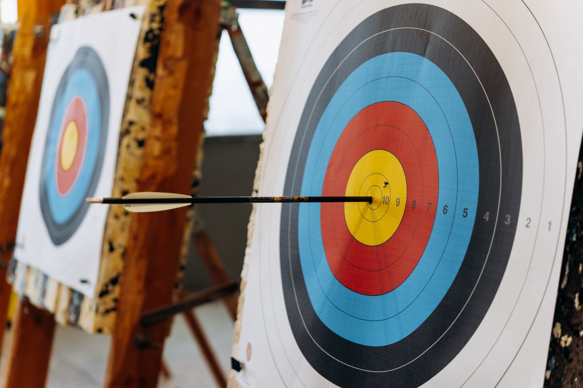Arrow hitting the bullseye of an archery target
