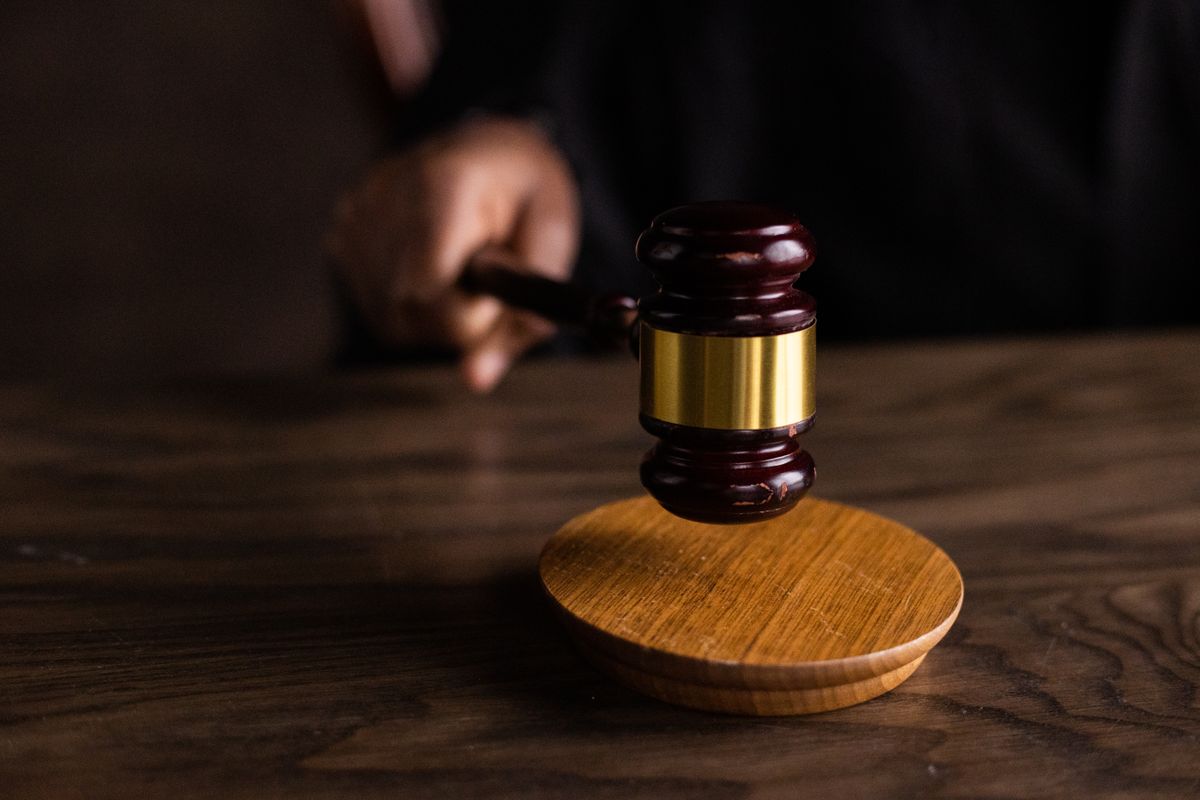 Wooden gavel resting on a sound block