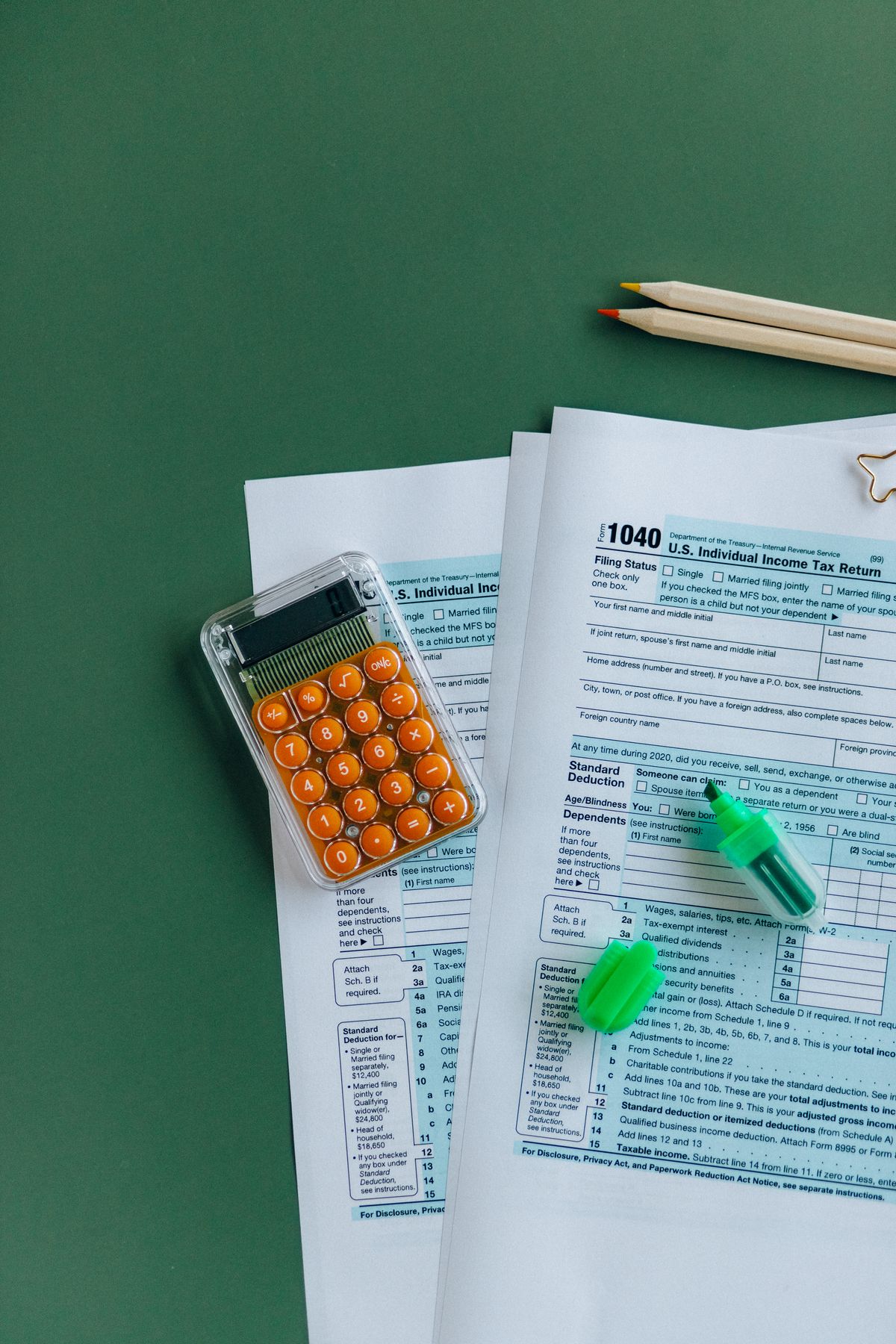 Tax return forms with a calculator and highlighter